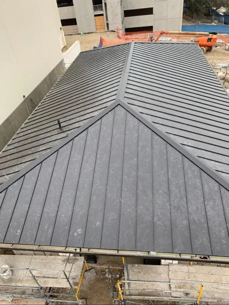 Commercial metal roof construction with crane equipment in Randolph Town